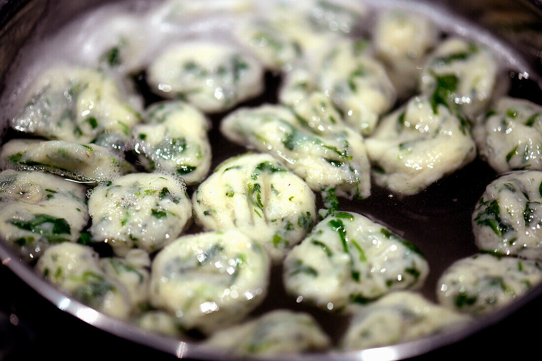 Preparing rocket gnocchi in boiling water