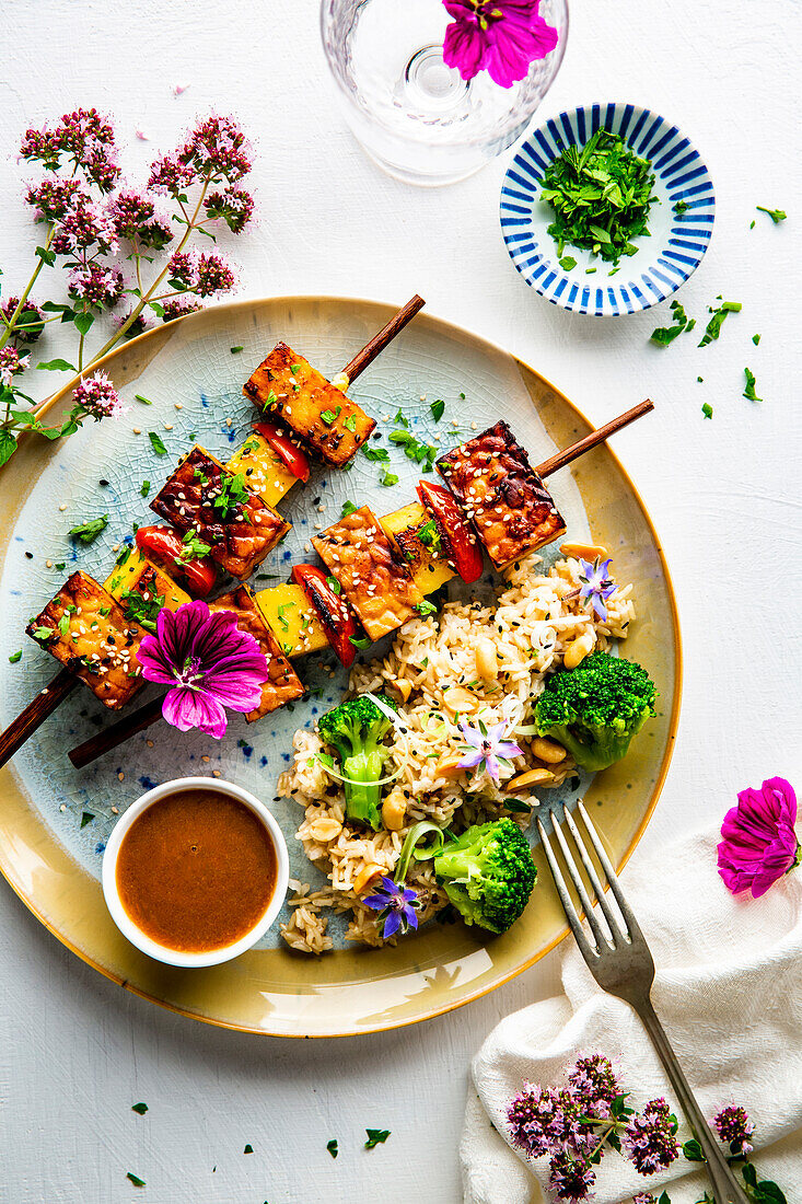 Spicy tempeh skewers with mango, orange, and peanut sauce