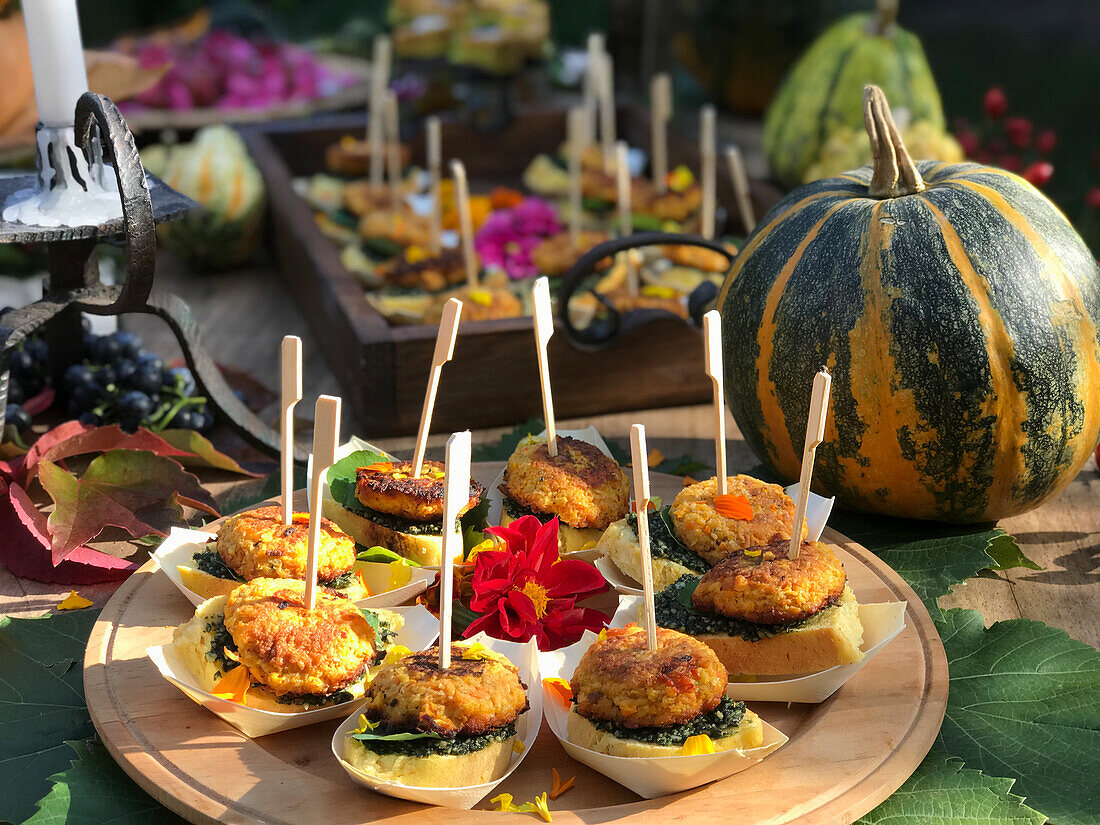 Pumpkin cakes with edible flowers and pesto on pumpkin bread