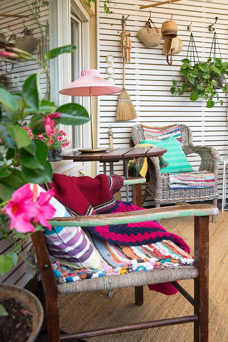 Cozy terrace with old chairs and white wooden wall as shelf and as partition wall