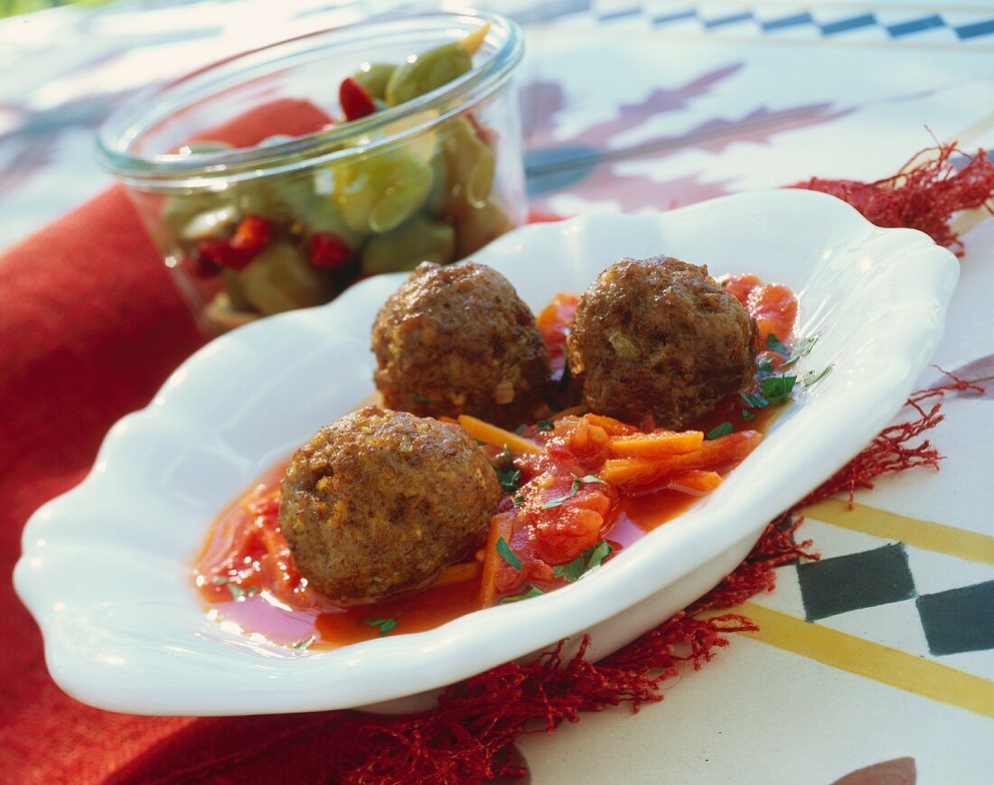 Meatballs on tomato & carrot sauce and bottled olives