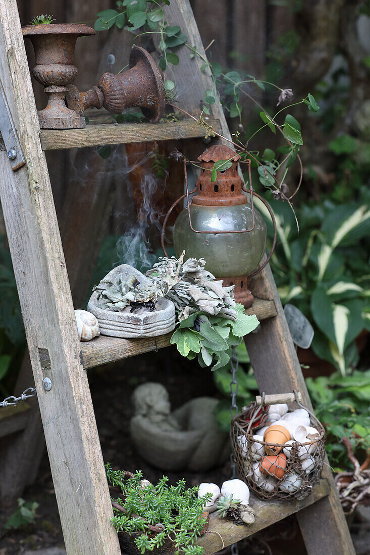 Vintage garden decoration with sage incense on a ladder