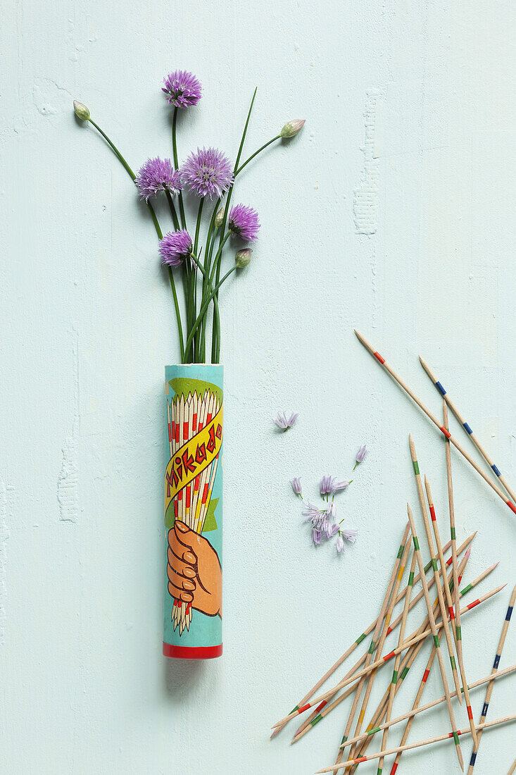 Chive flowers arranged in a Mikado tin with Mikado sticks