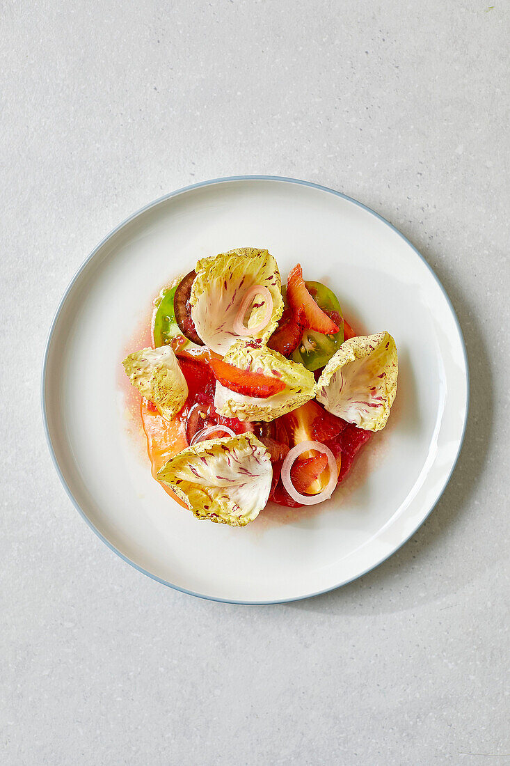 Tomato salad, blood orange and green olive dressing
