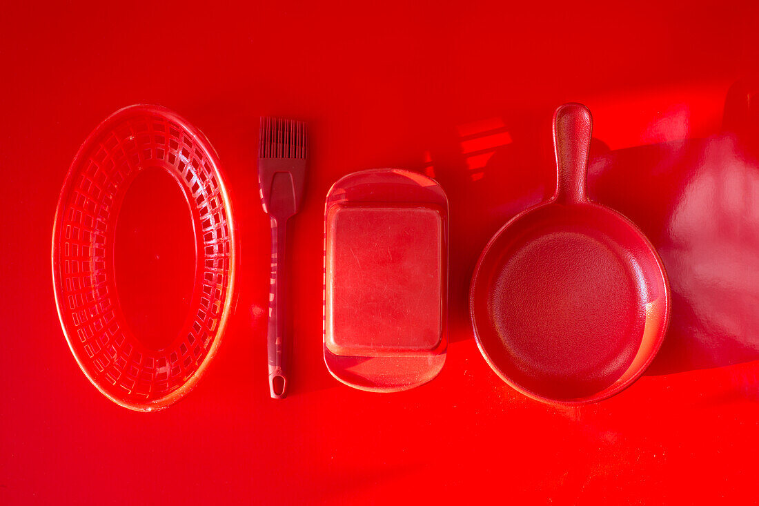 Kitchen utensils on red background