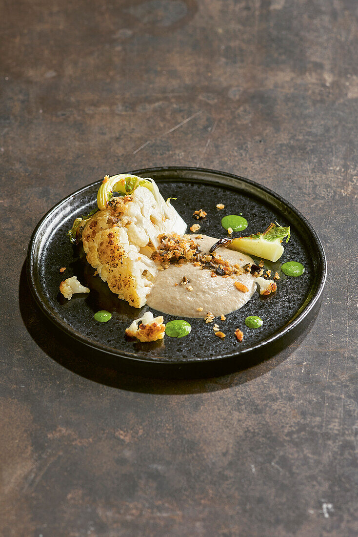 Roasted cauliflower with morel espuma and black walnuts (molecular gastronomy)