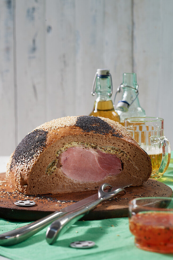 Ham in soccer ball shaped bread dough for the game night