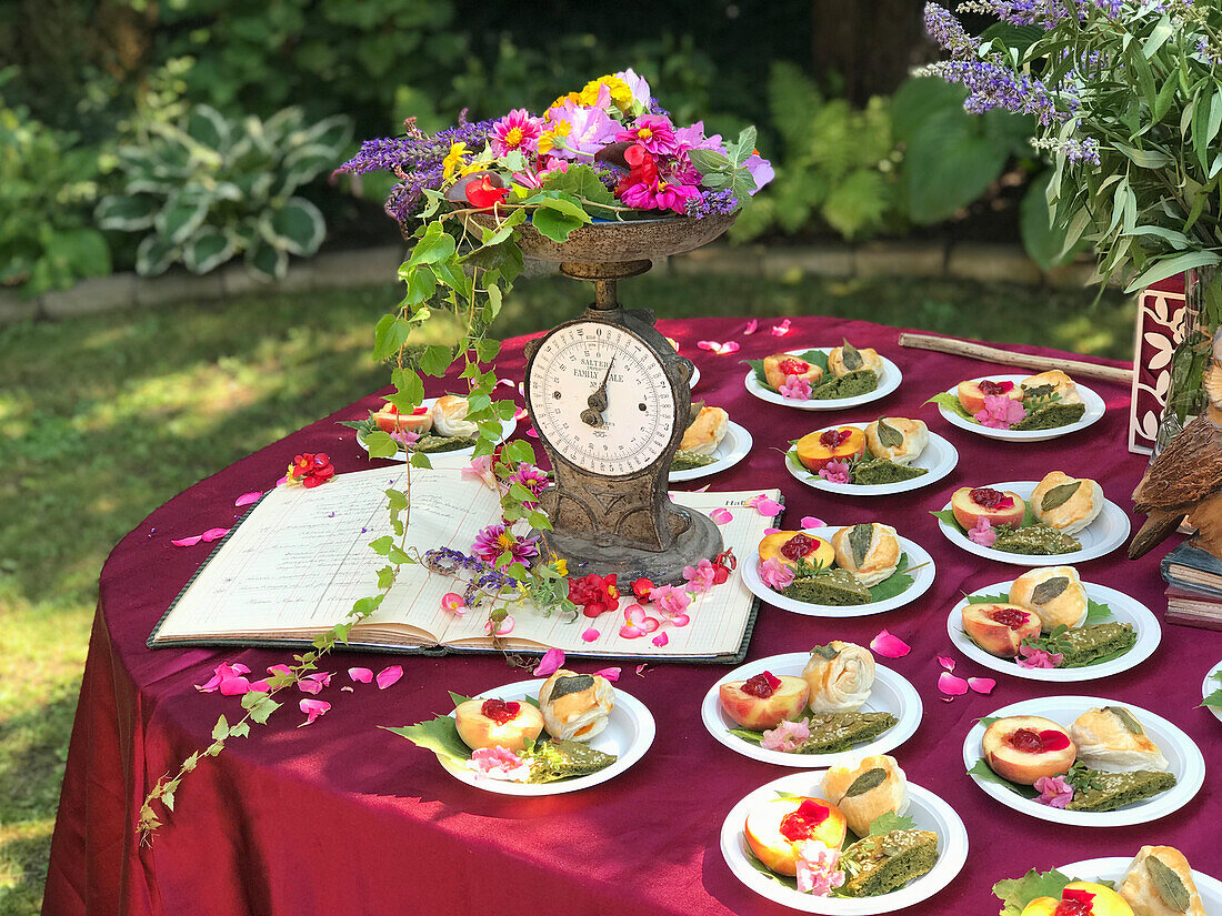 Sweet and savoury dishes with herbs and edible flowers on several plates