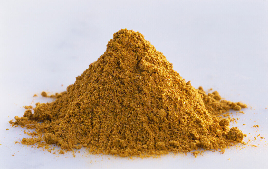 A heap of curry powder on a light background