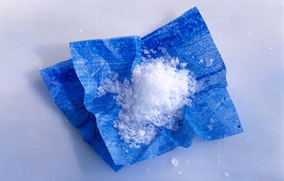 Sea salt on blue paper