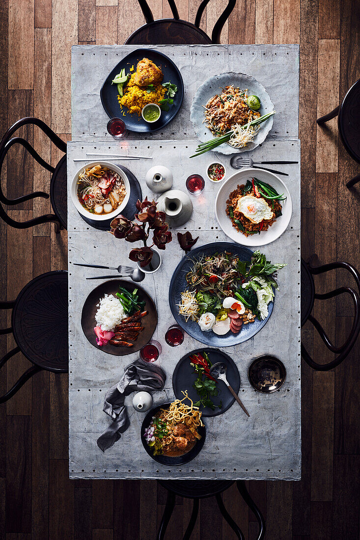 Gedeckter Tisch mit verschiedenen thailändischen Gerichten