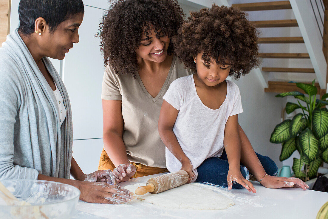 Multi-generation family preparing cookies