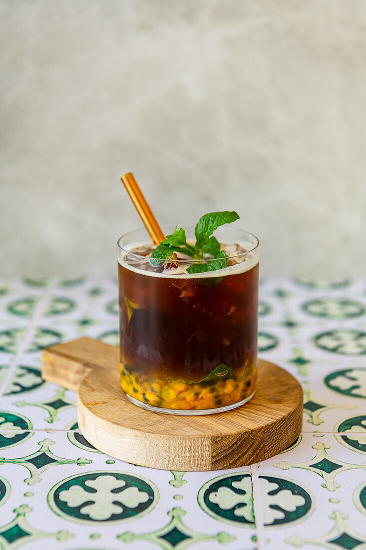 Iced coffee with passion fruit, ginger beer, mint, and double espresso