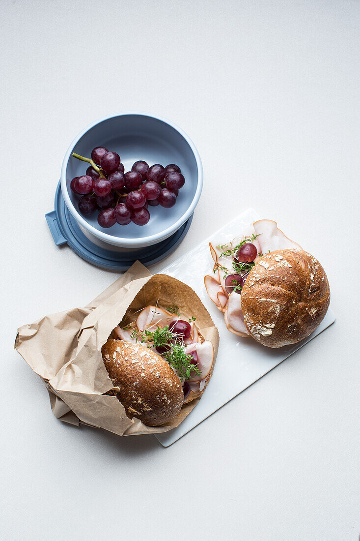 Wholewheat roll with turkey breast and blue grapes