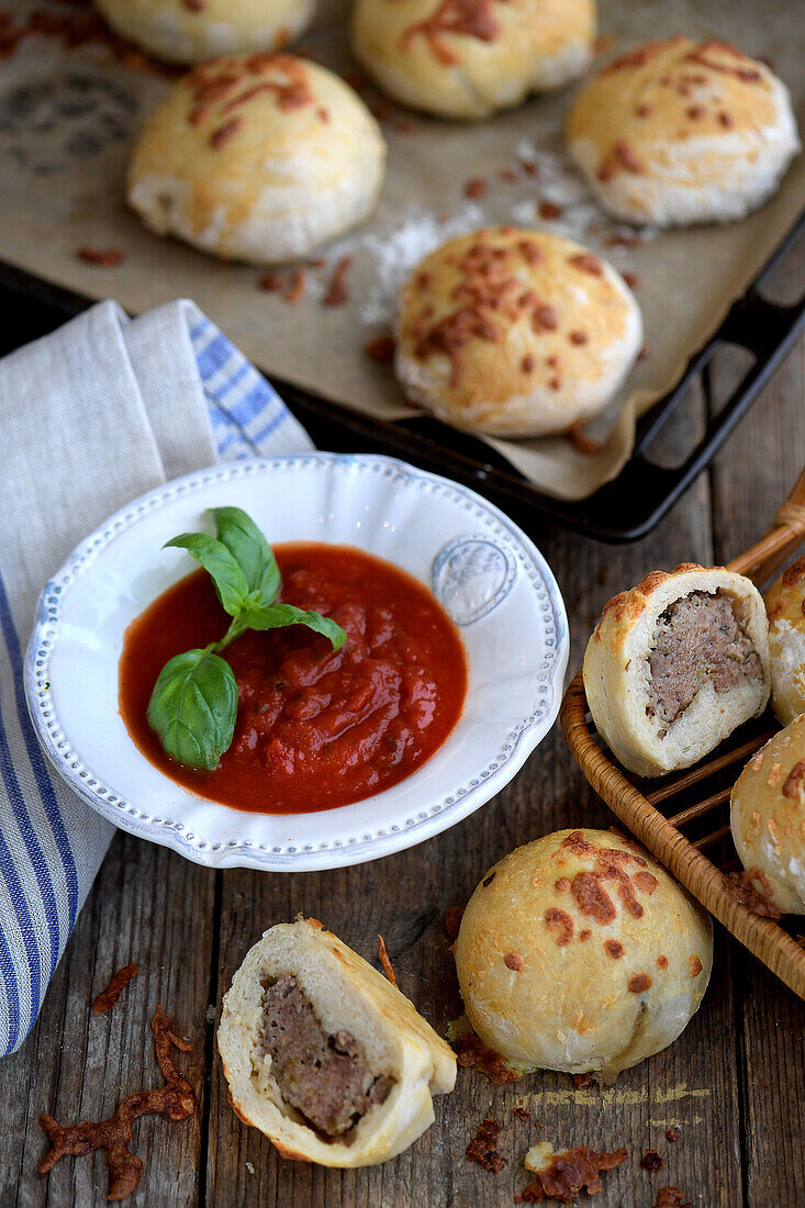 Buns filled with ground beef, served with tomato sauce