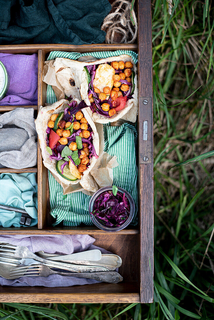 Vegetarian stuffed pita bread with spicy chickpeas, pickled red cabbage, tomato, cucumber, fried haloumi cheese and mint