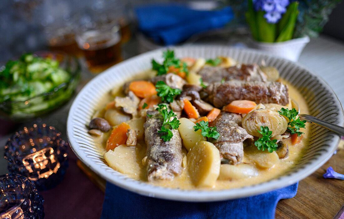 Winter stew with potatoes, onions, and stuffed rolled thinly sliced steak