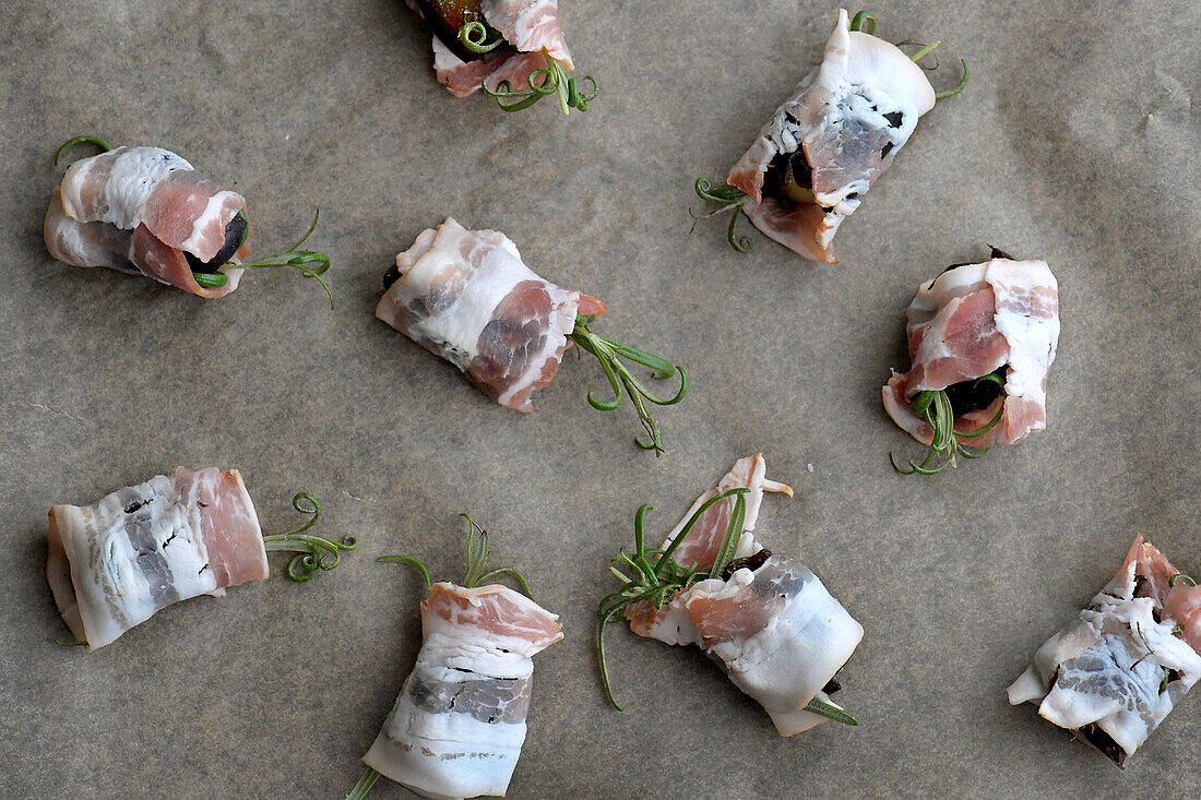 Dates wrapped in bacon with rosemary and Comte cheese