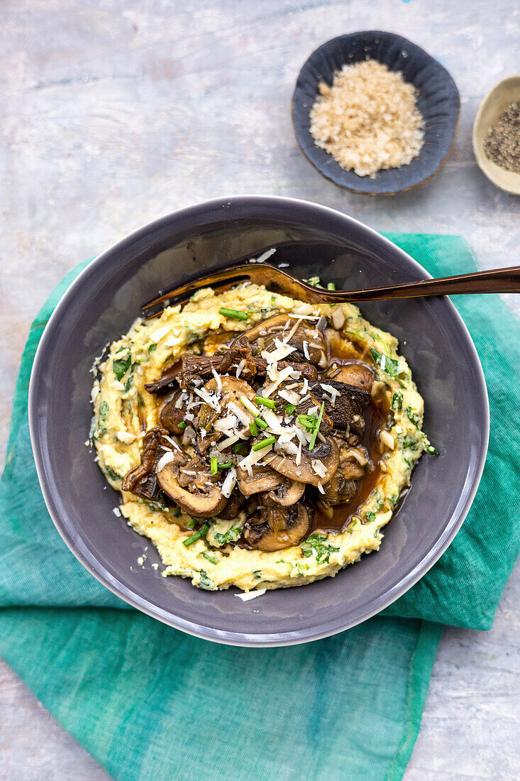 Cheesy polenta mash topped with mushrooms and chives