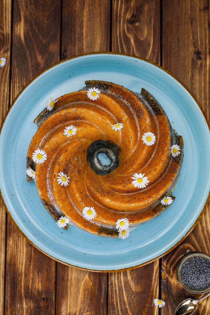 Poppy seed meringue cake decorated with daisies