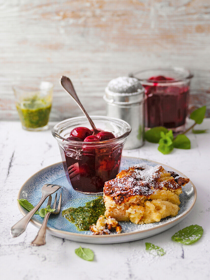 Traditional quark pudding with cherry compote and sweet mint pesto
