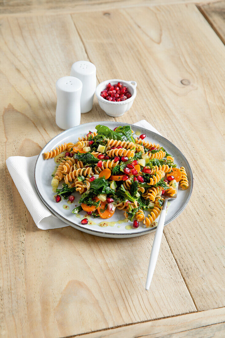 Red lentil pasta salad with kale and pomegranate seeds