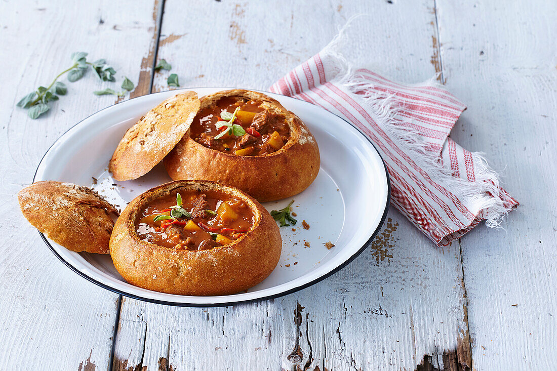 Goulash soup with pepperoni in a loaf of bread