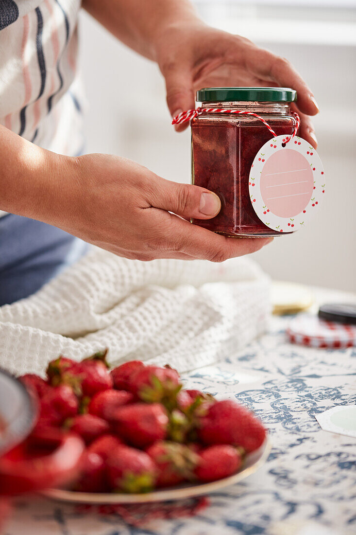 Homemade strawberry jam in a jar with label