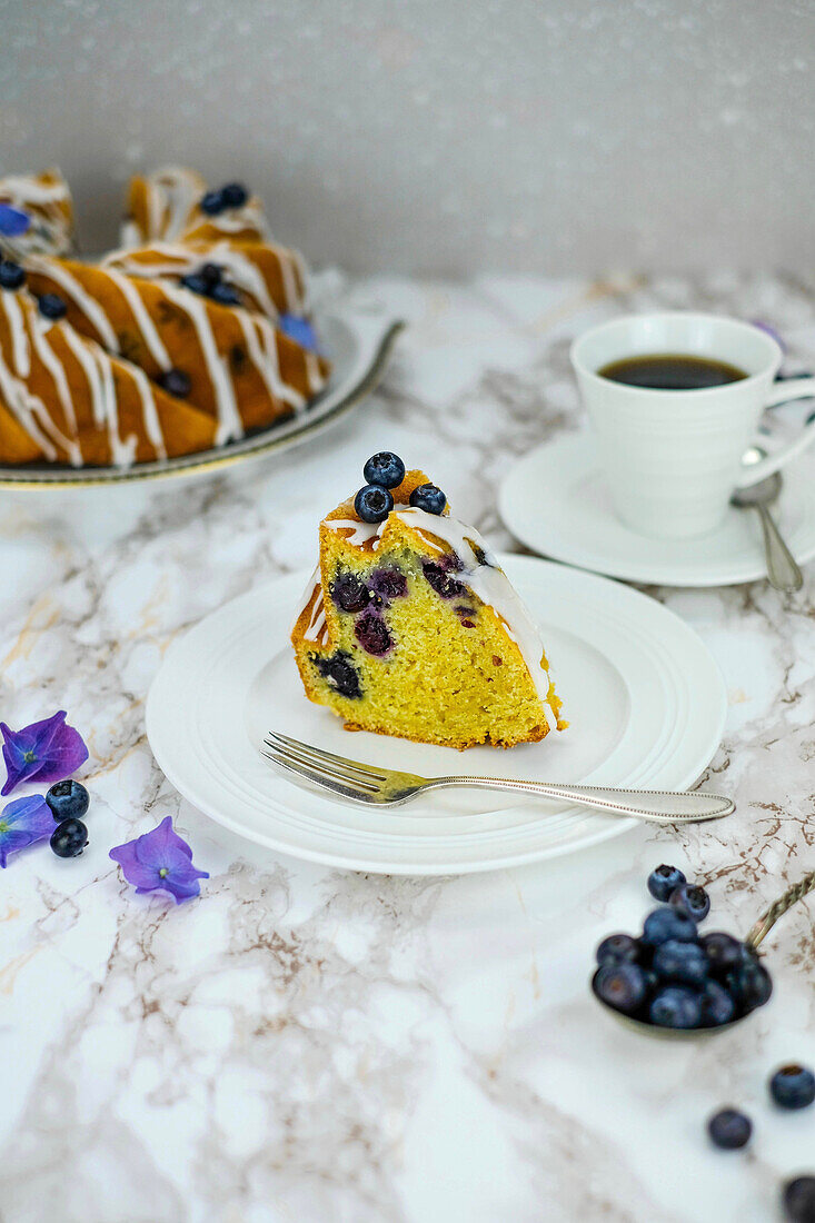 A piece of blueberry-gugelhupf with coffee