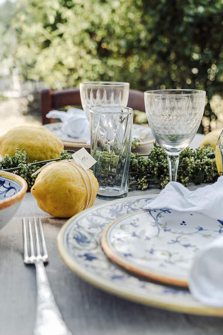 Table set with lemons, in the garden