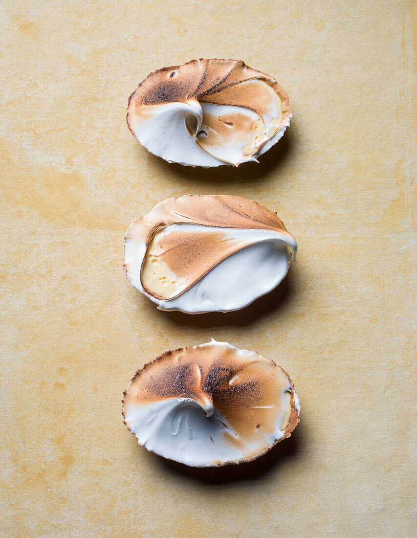 Three lemon meringue tarts with topping
