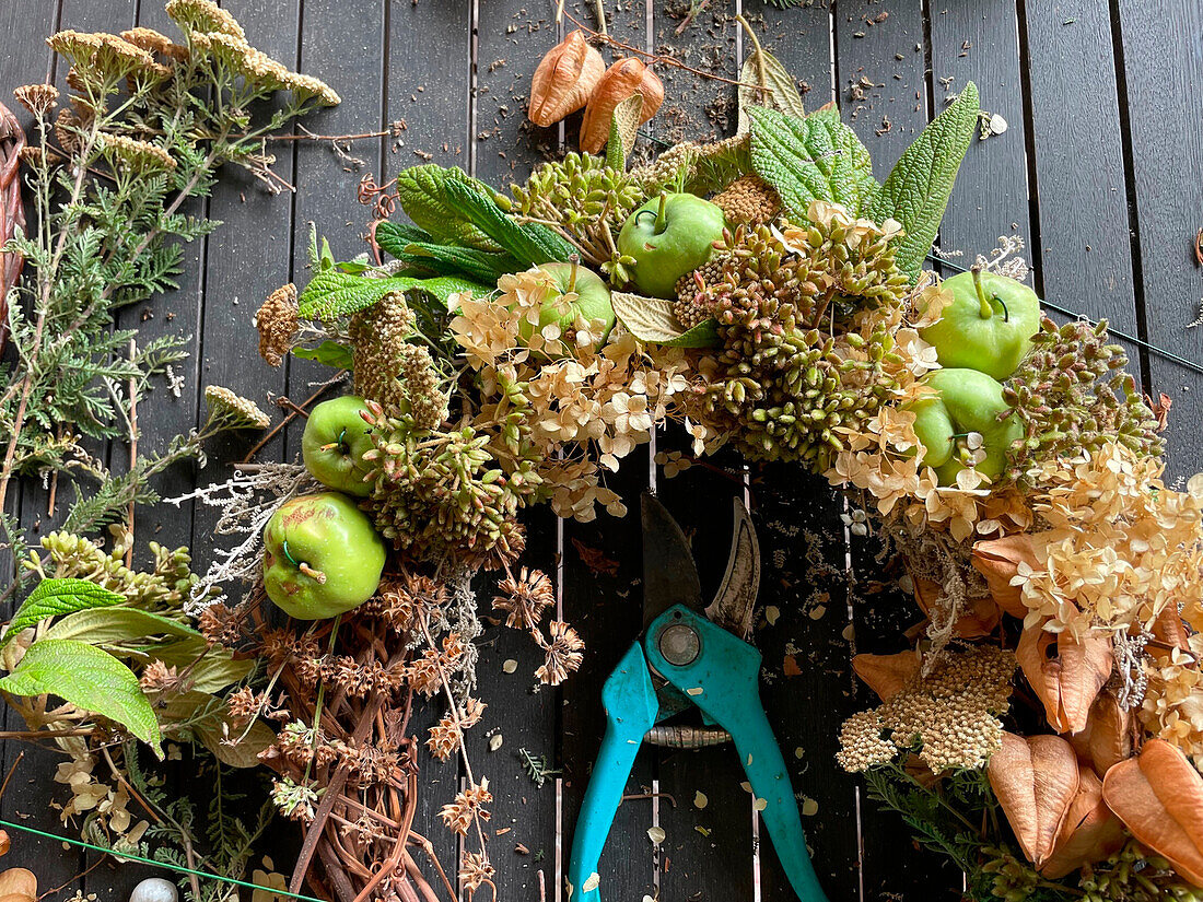 DIY wreath made from dried blossoms and green apples