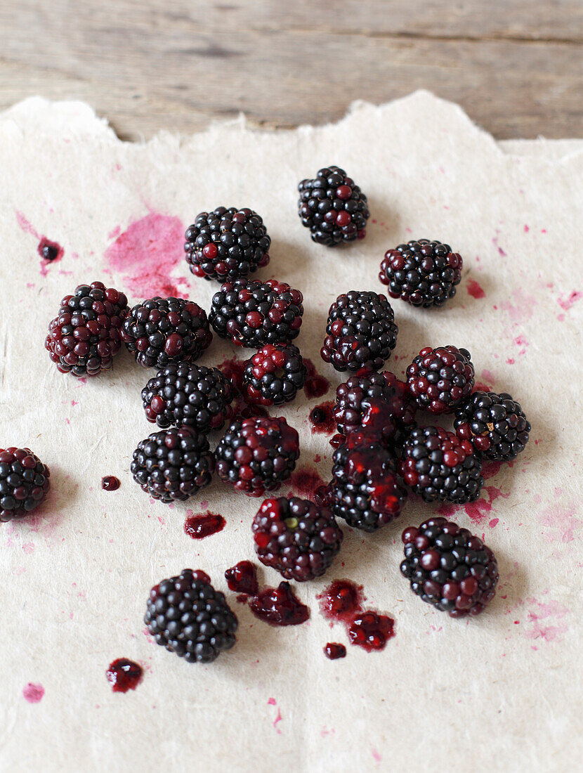 Fresh blackberries on a light piece of paper