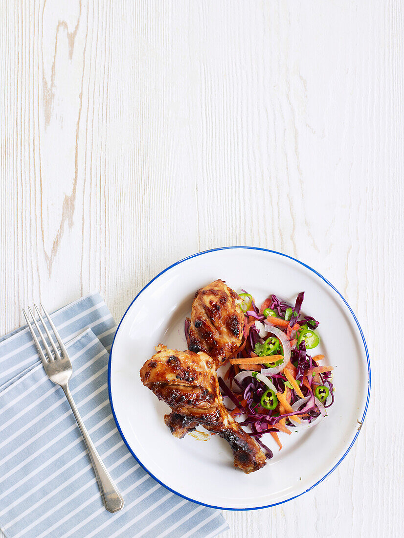 Sticky chicken drumsticks with Asian slaw