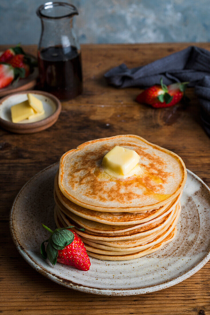 Stack of American pancakes topped with butter