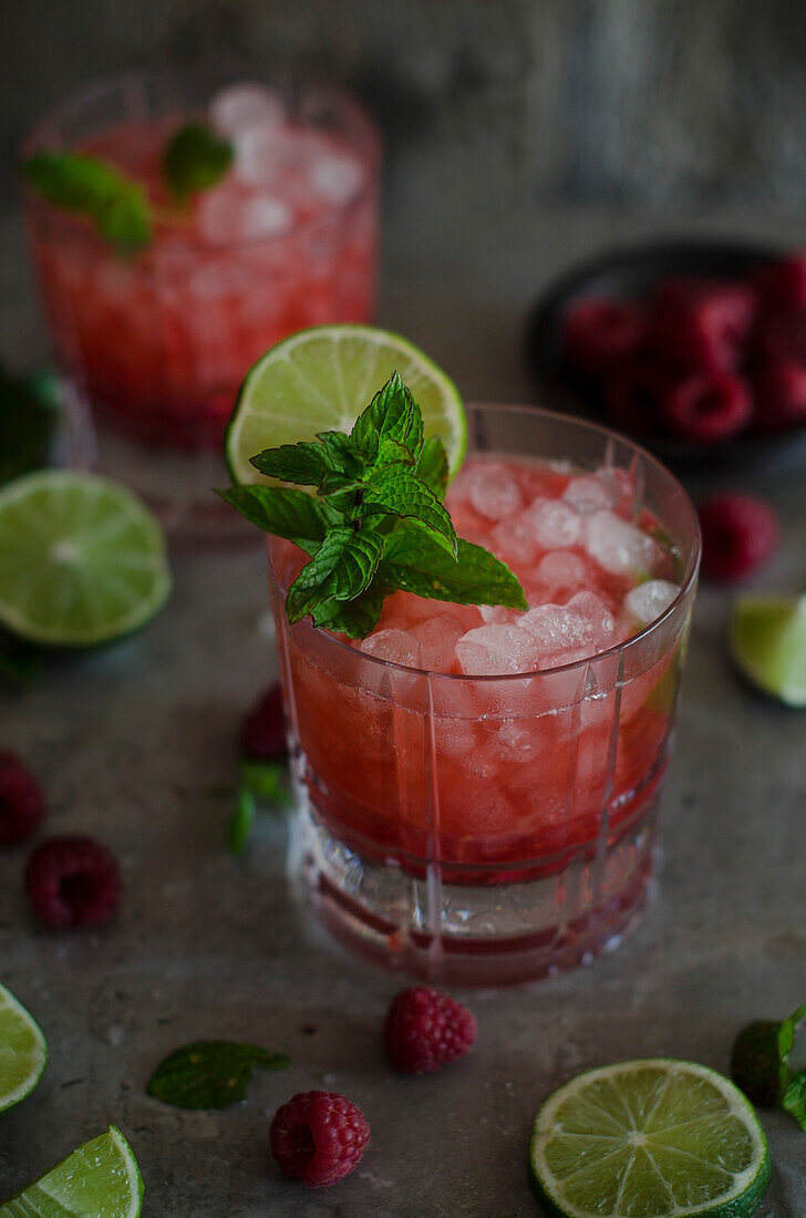 Raspberries, limes and mint, ingredients for a Caipiroska cocktail