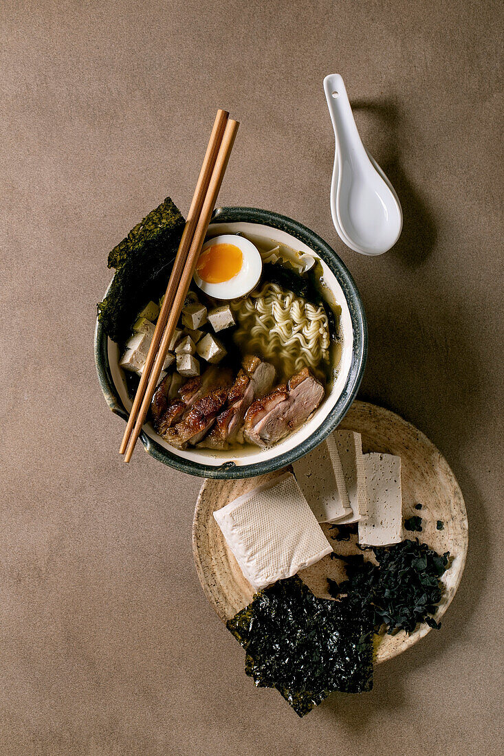 Ramen soup with tofu, grilled duck breast, seaweed nori chips, and boiled egg
