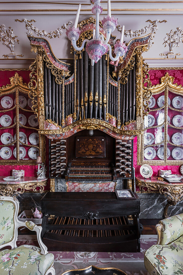 Victorian plates surround organ with walls in Raspberry silk