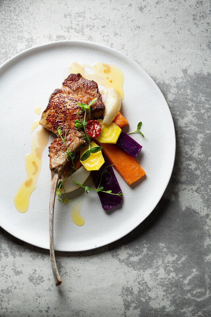 Veal tomahawk on a bed of vegetables