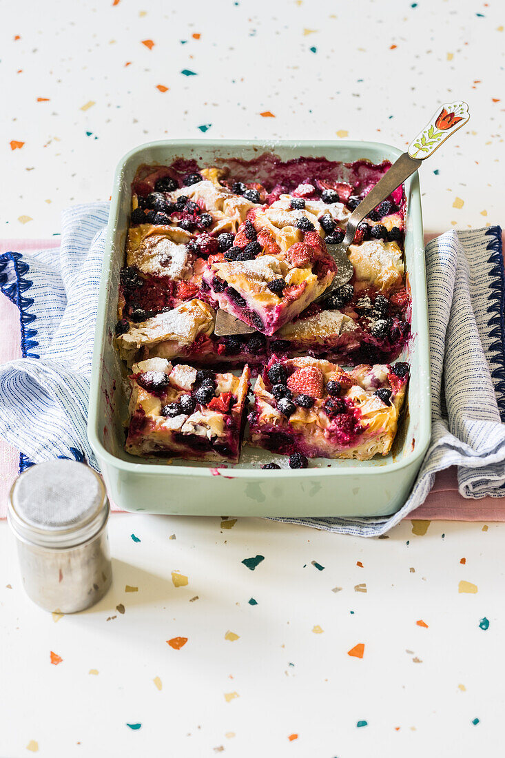 Phyllo dough custard bake with berries (black and red raspberries and strawberries) dusted with icing sugar