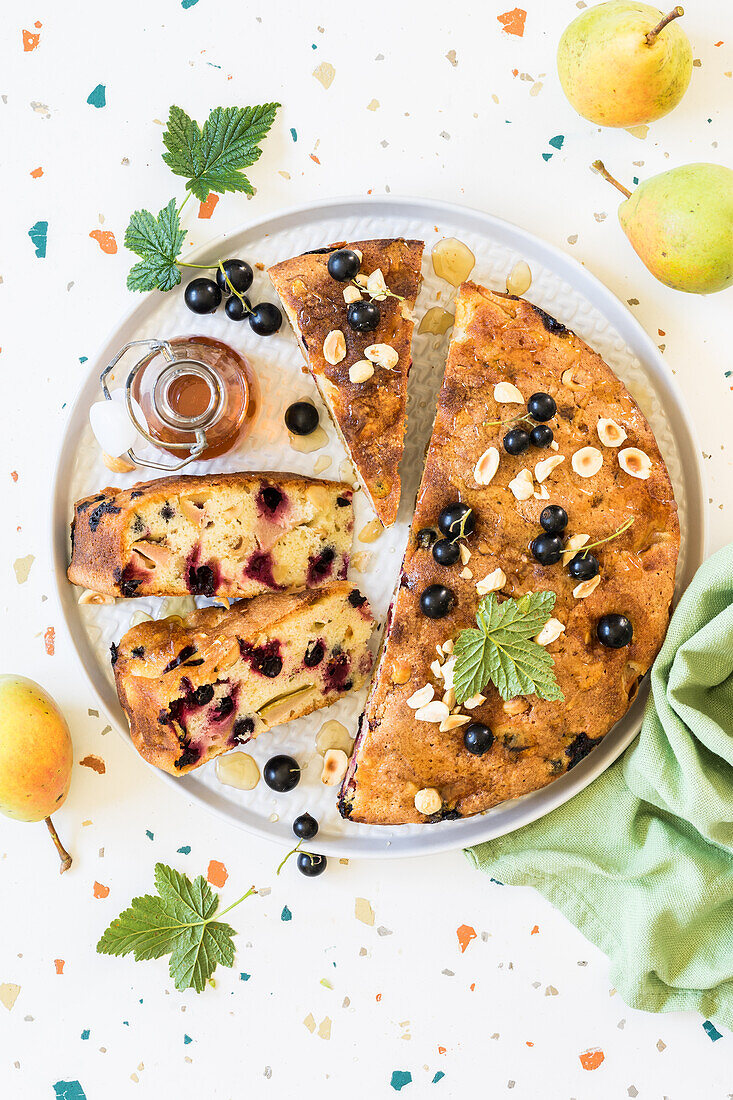 Pear, blackcurrant and hazelnut cake drizzled with honey