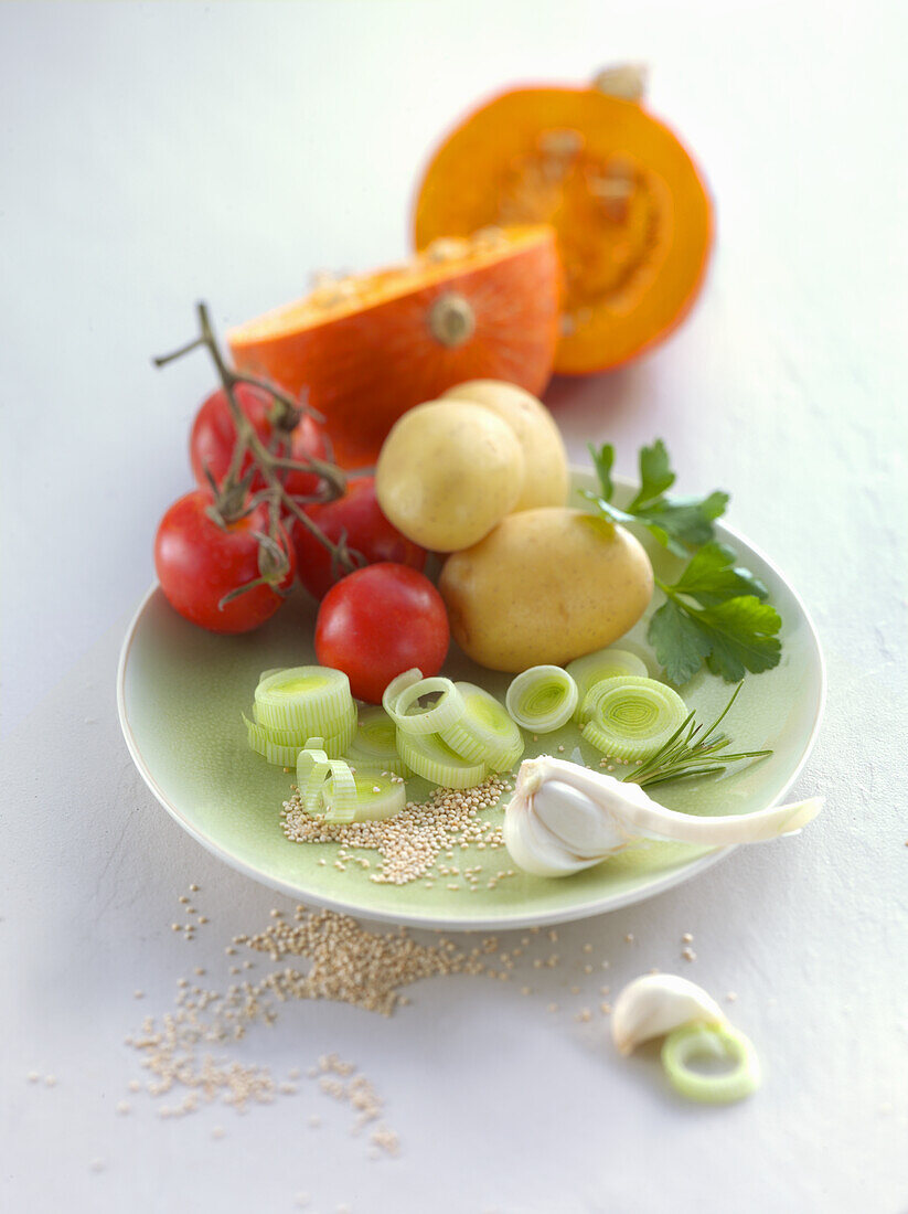An arrangement of pumpkin, tomatoes, potatoes, leek and garlic