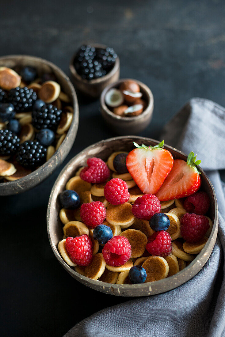 Breakfast bowls with mini pancake cereal and berries