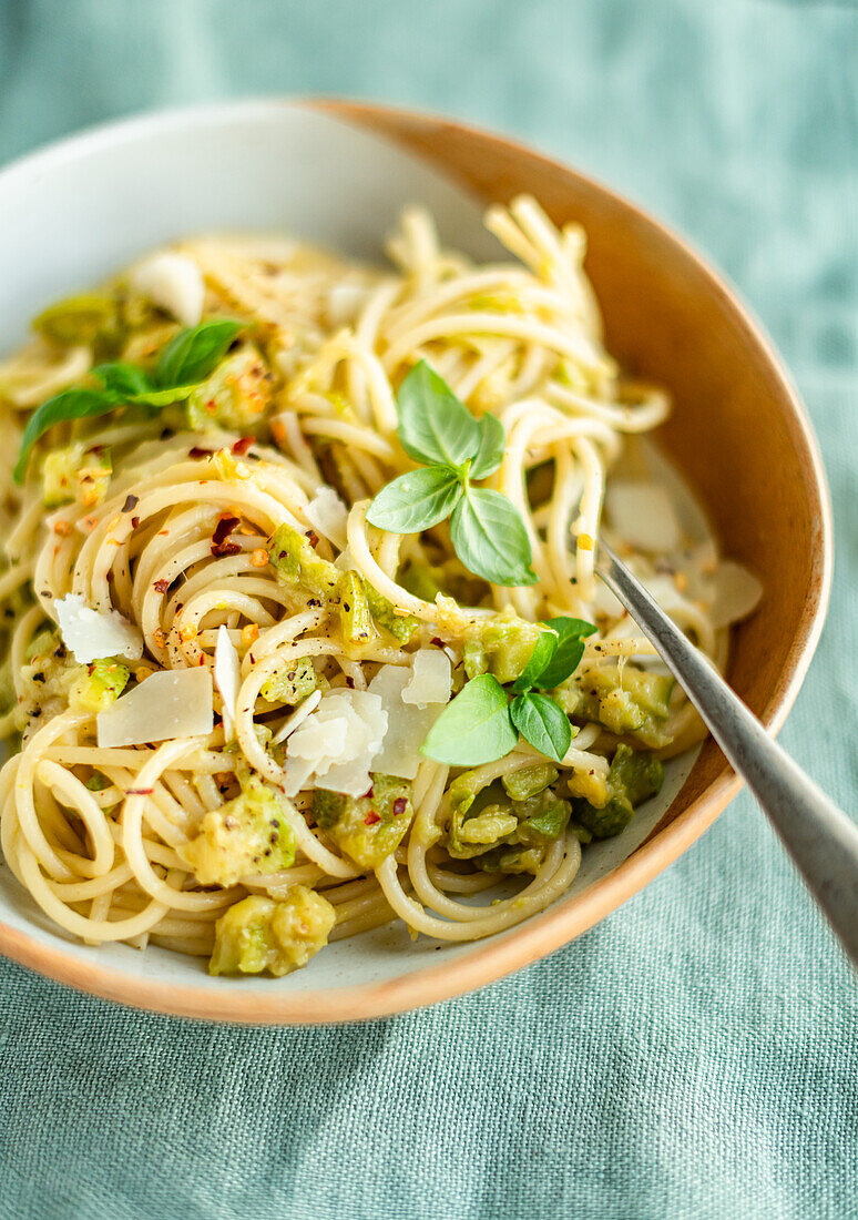 Spaghetti with zucchini sauce, chilies, basil, and Parmesan cheese