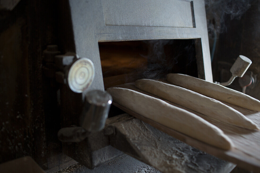 Baguettes being put in the oven