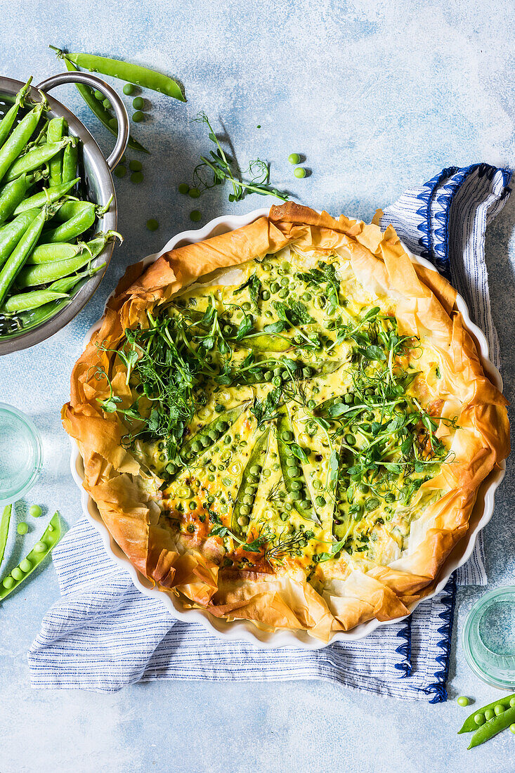 Phyllo dough quiche with green peas, edamame beans, greens, ricotta, eggs and parmesan