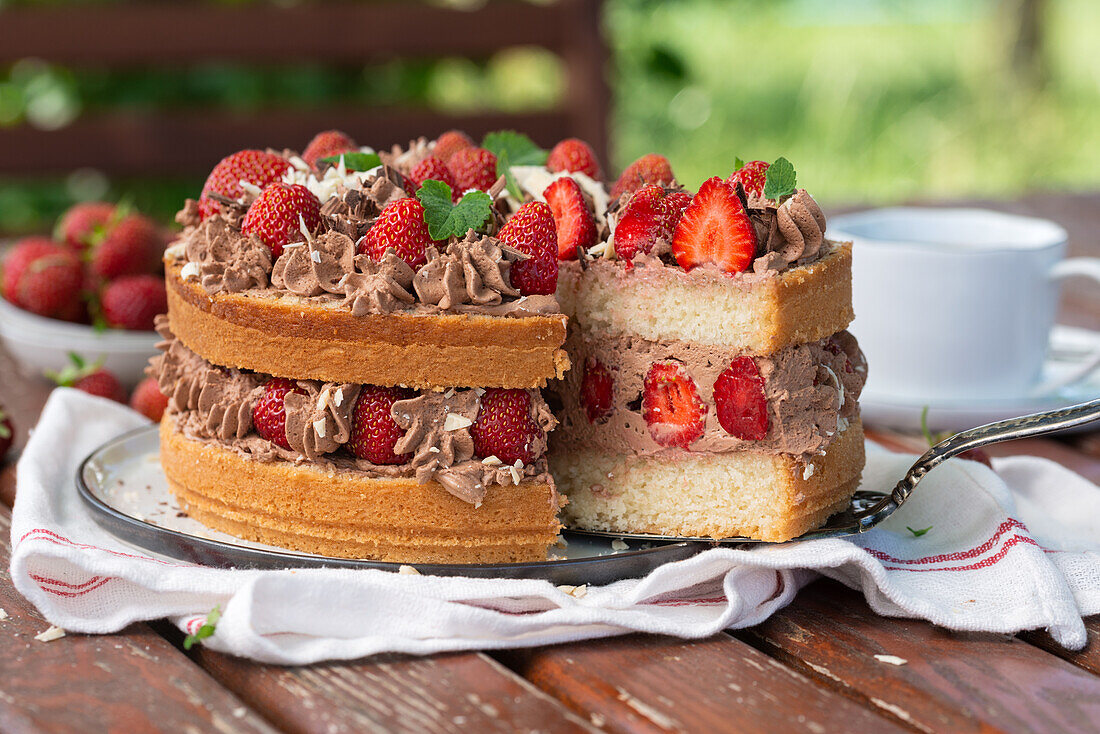 Vegan sponge cake with chocolate cream and strawberries