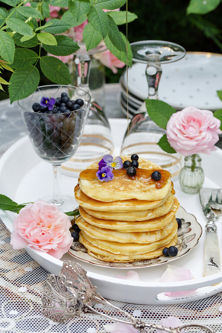 Pancakes with wild blueberries and maple syrup