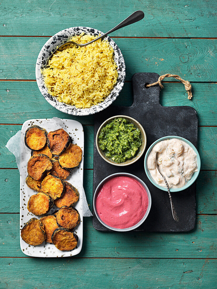 Turmeric rice, baked eggplant, and three kinds of dip