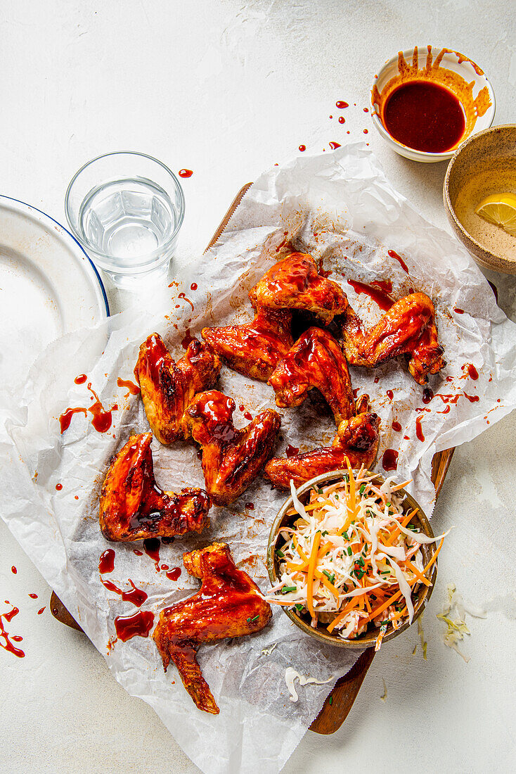 Chicken wings in spicy bbq sauce with coleslaw salad